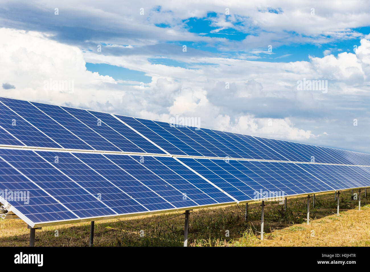 photovoltaic panels under cloudy bright blue sky Stock Photo
