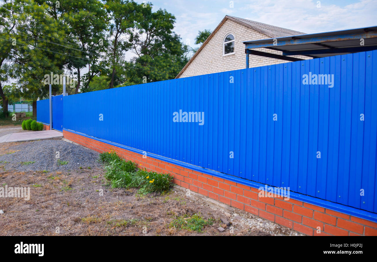 Blue gate and fence. Fence of the private house with blue fence and a