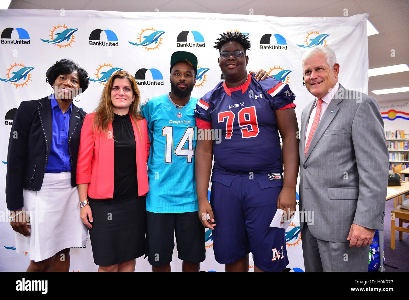 MIAMI, FL - SEPTEMBER 20: BankUnited Vice President of Community Development & Outreach Katrina Wright, Miramar High School Principal Maria Formoso, Miami Dolphins Wide Receiver (#14) Jarvis Landry, Stephen Gordon and BankUnited Senior Executive Vice President Gerry Litrento surprise the Miramar Patriots varsity football team prior to the team's practice as part of the 4 Downs for Finance financial literacy program sponsored by BankUnited. Landry share his thoughts on the importance of financial literacy at Miramar High School Media Center on September 20, 2016 in Miramar, Florida. Credit: MPI Stock Photo