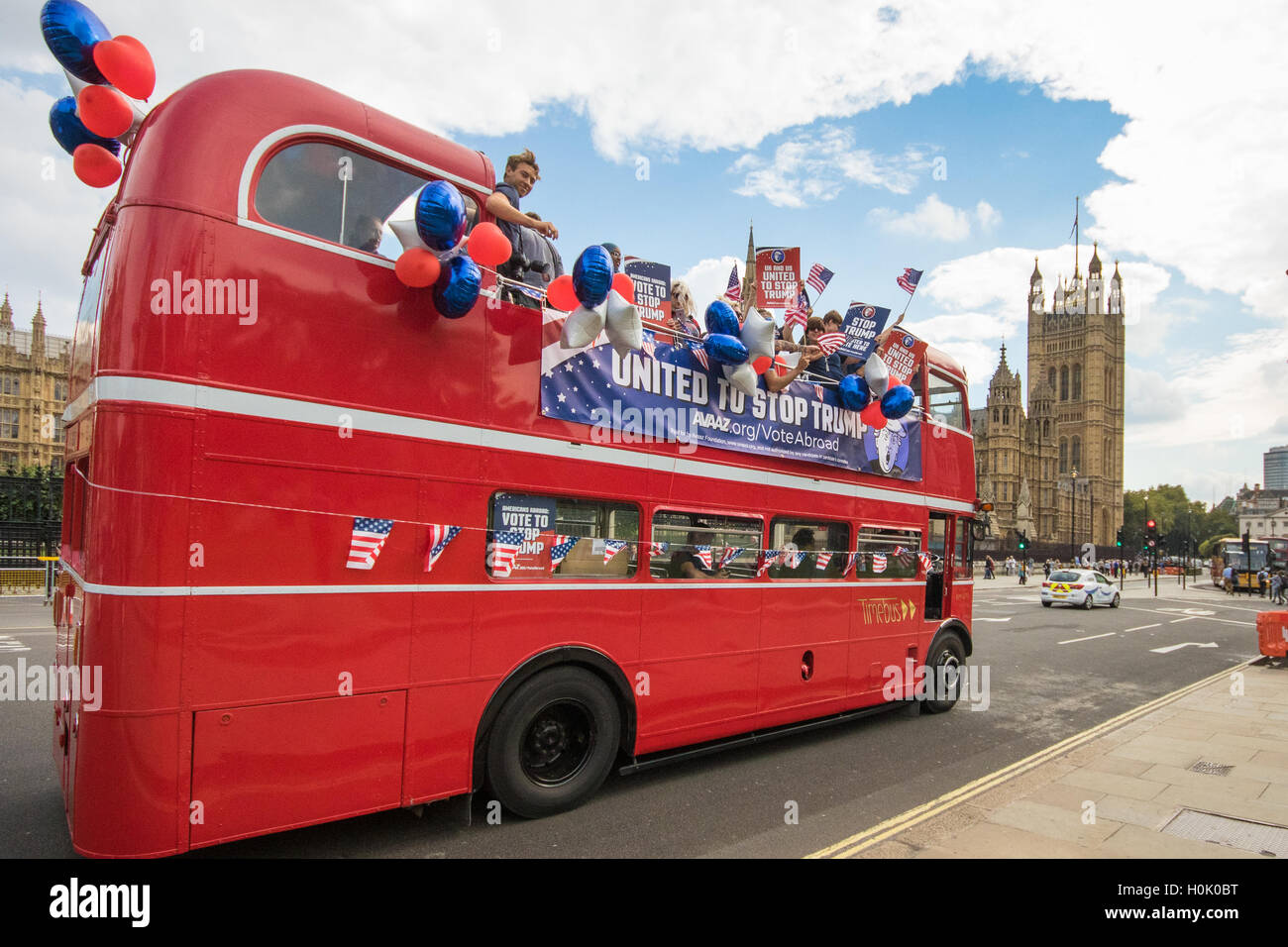 London, UK. 21st Sep, 2016. London, September 21st 2016. A "Stop Trump" open topped red London double-decker bus passes the Houses of Parliament and Big Ben in London in a bid to encourage US expats to register to vote in the Presidential election, expecting the majority of them to be more inclined to support Hilary Clinton. Credit:  Paul Davey/Alamy Live News Stock Photo