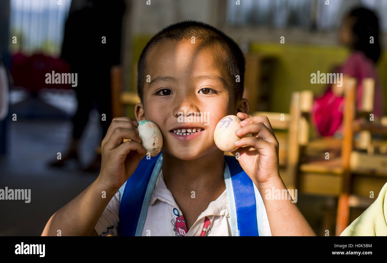 China. 22nd Sep, 2016. A child holds eggs in Congjiang County