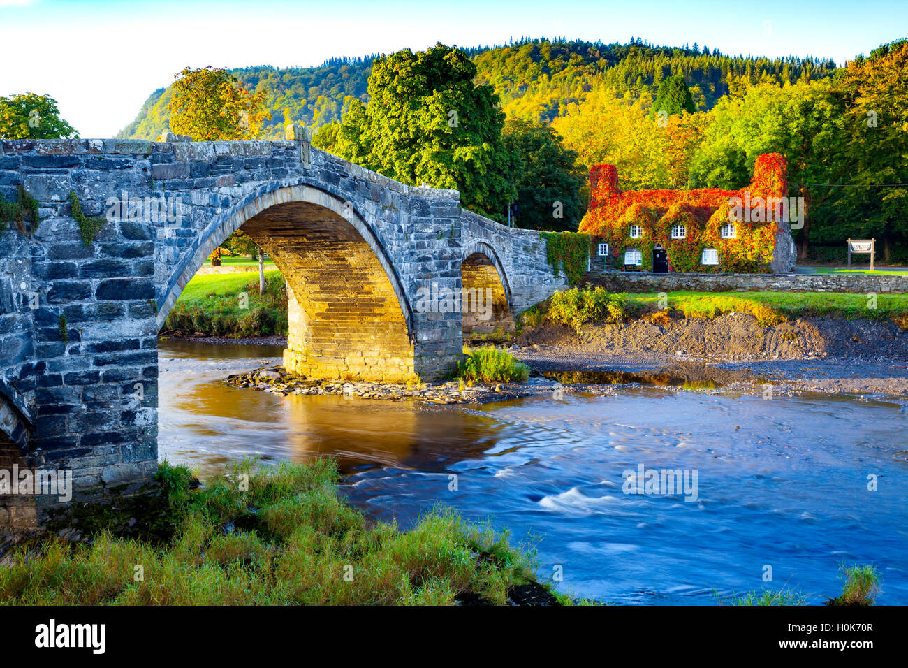 Llanrwst, Conwy, Wales, UK  The sunrise bathes Llanrwst Tu Hwnt I’r Bont Tea Room or Hwnt i’r Bont Tearooms on the day of the Autumn Equinox. The time or date (twice each year) at which the sun crosses the celestial equator, when day and night are of equal length. Stock Photo