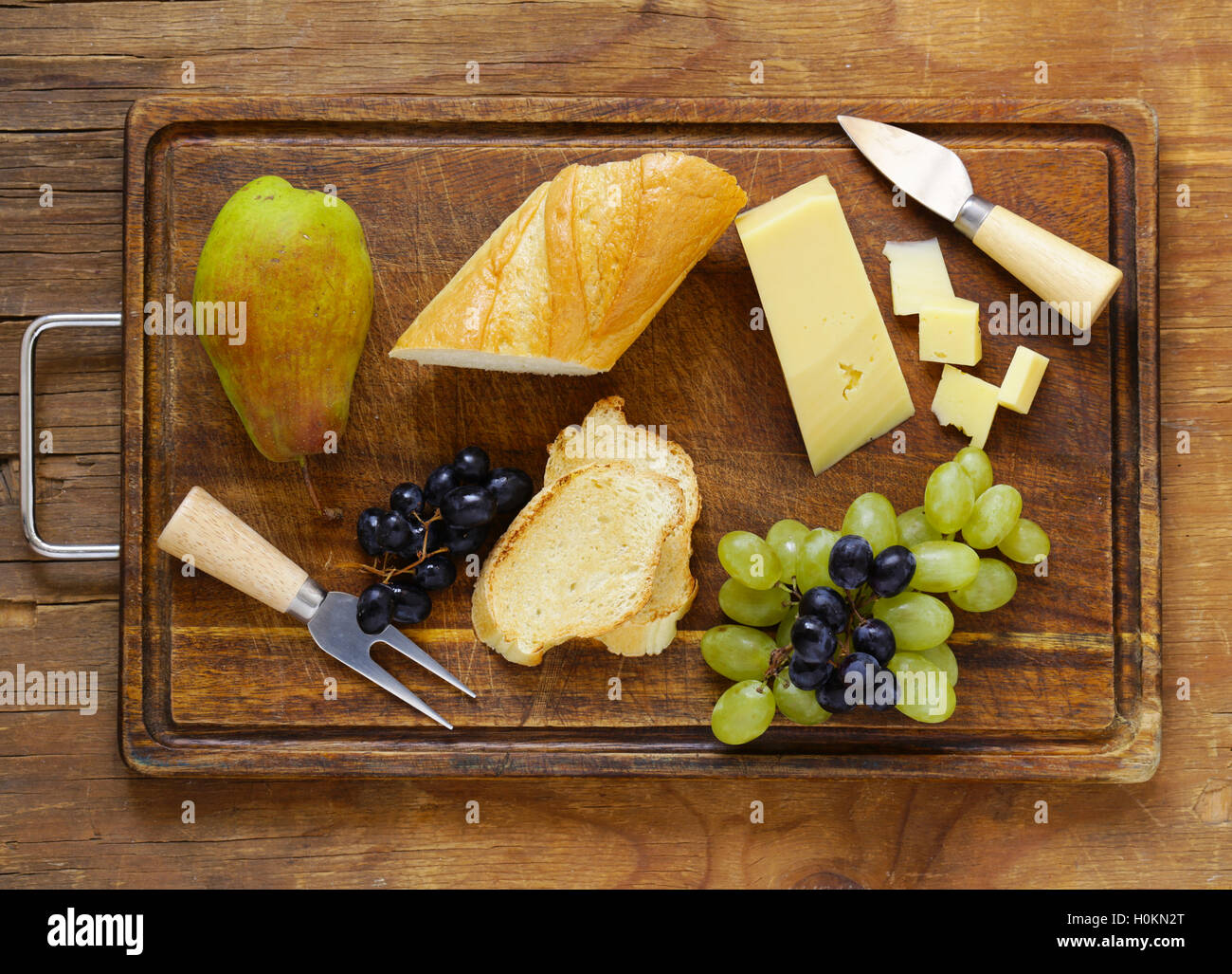 cheese board with grapes, pear and baguette Stock Photo