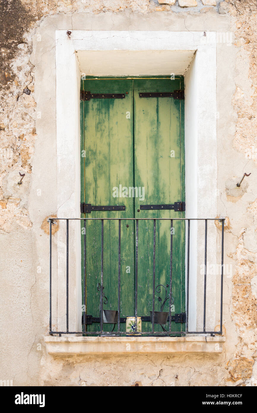 Green Shutters, Saint-Guilhem-le-Desert Village, Languedoc, France Stock Photo