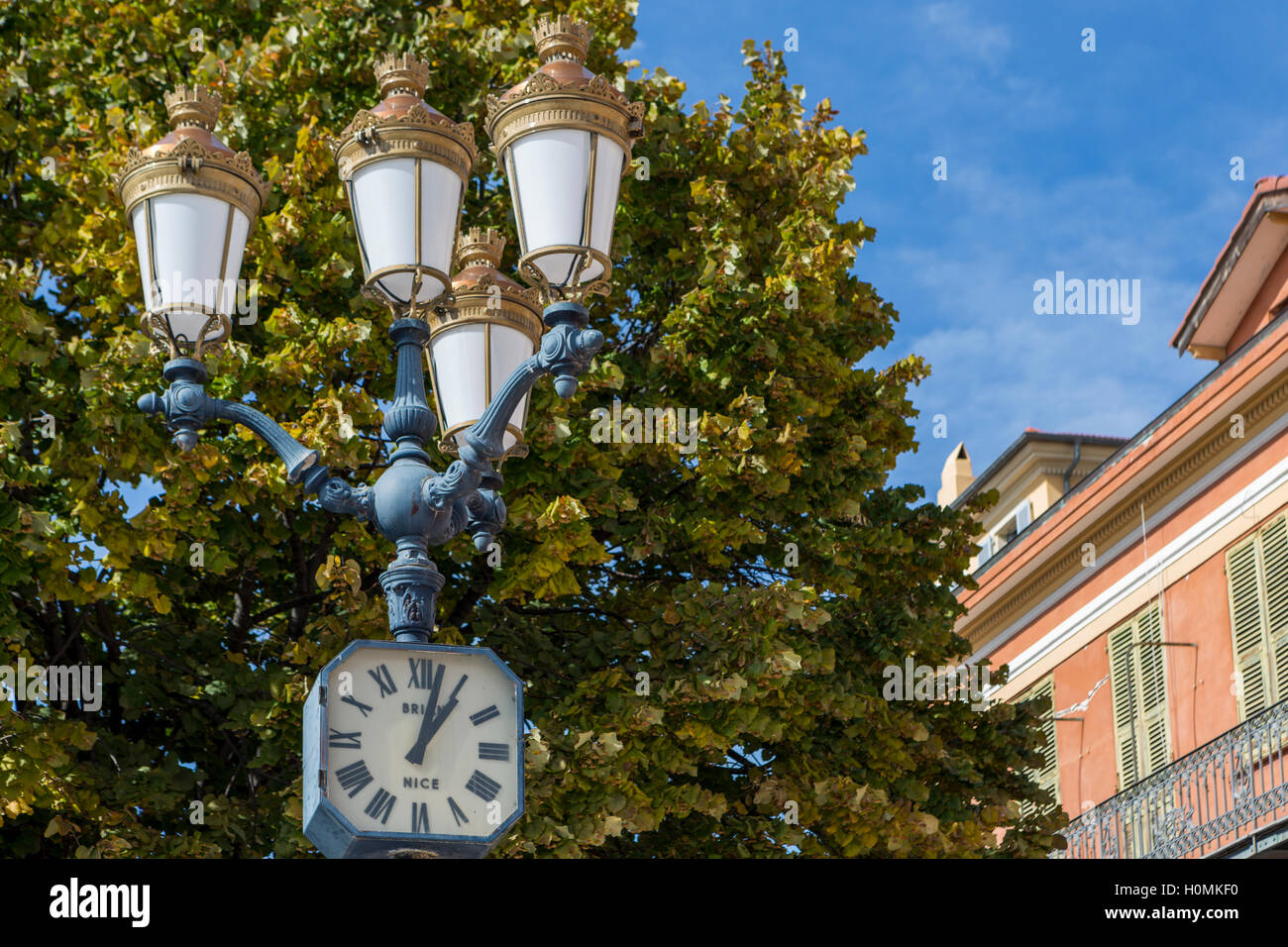 Streetlight and clock, Nice, Alpes-Maritimes,  French Riviera, France Stock Photo