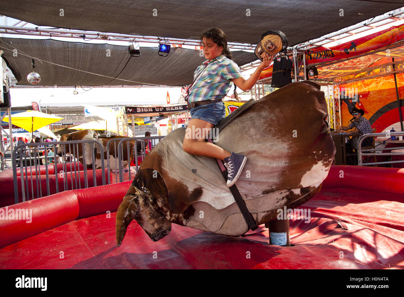 Riding the mechanical bull, Los Angeles County Fair, Pomona Fairplex, Pomona, California, USA Stock Photo