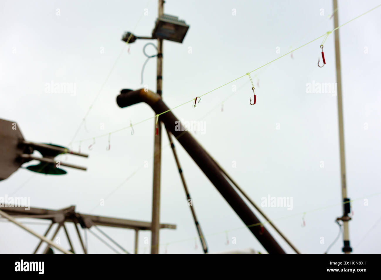 Fishing hook hanging on a fishing line Stock Photo - Alamy