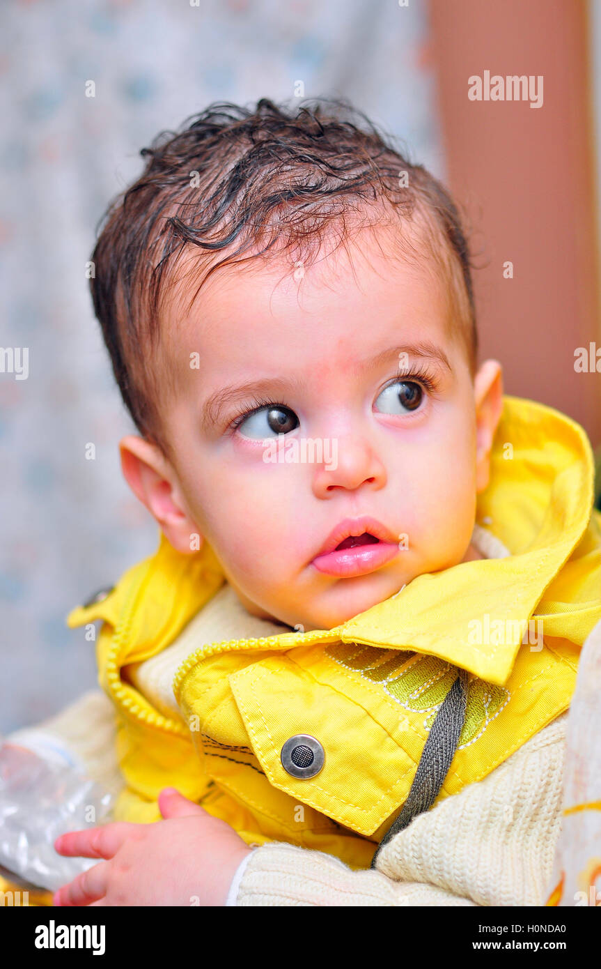 A Cute Boy in Yellow Looking Away Stock Photo