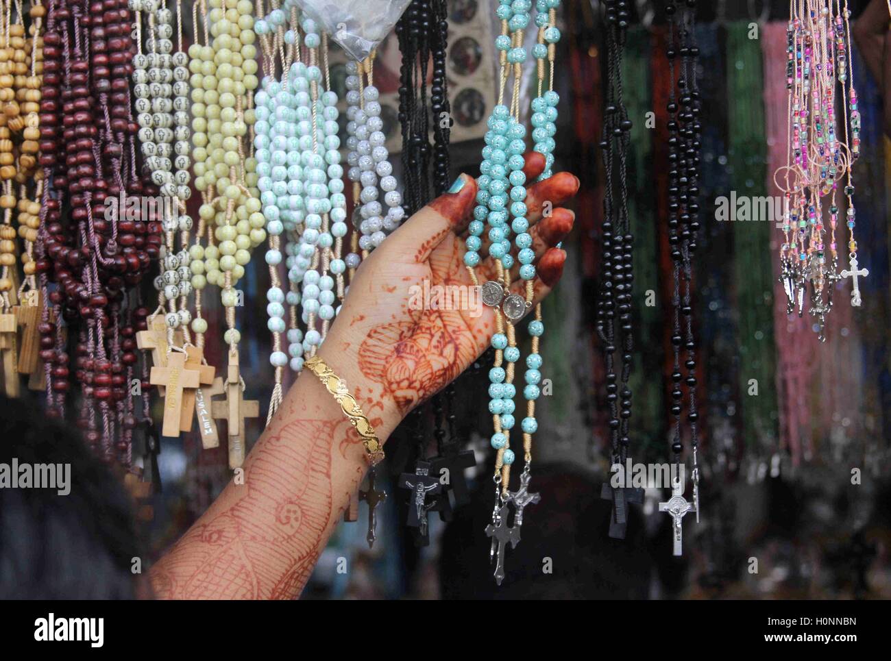 faithful checks various rosaries scapulars display street stall leading Mount Mary's Basilica Mount Mary's festival Mumbai Stock Photo
