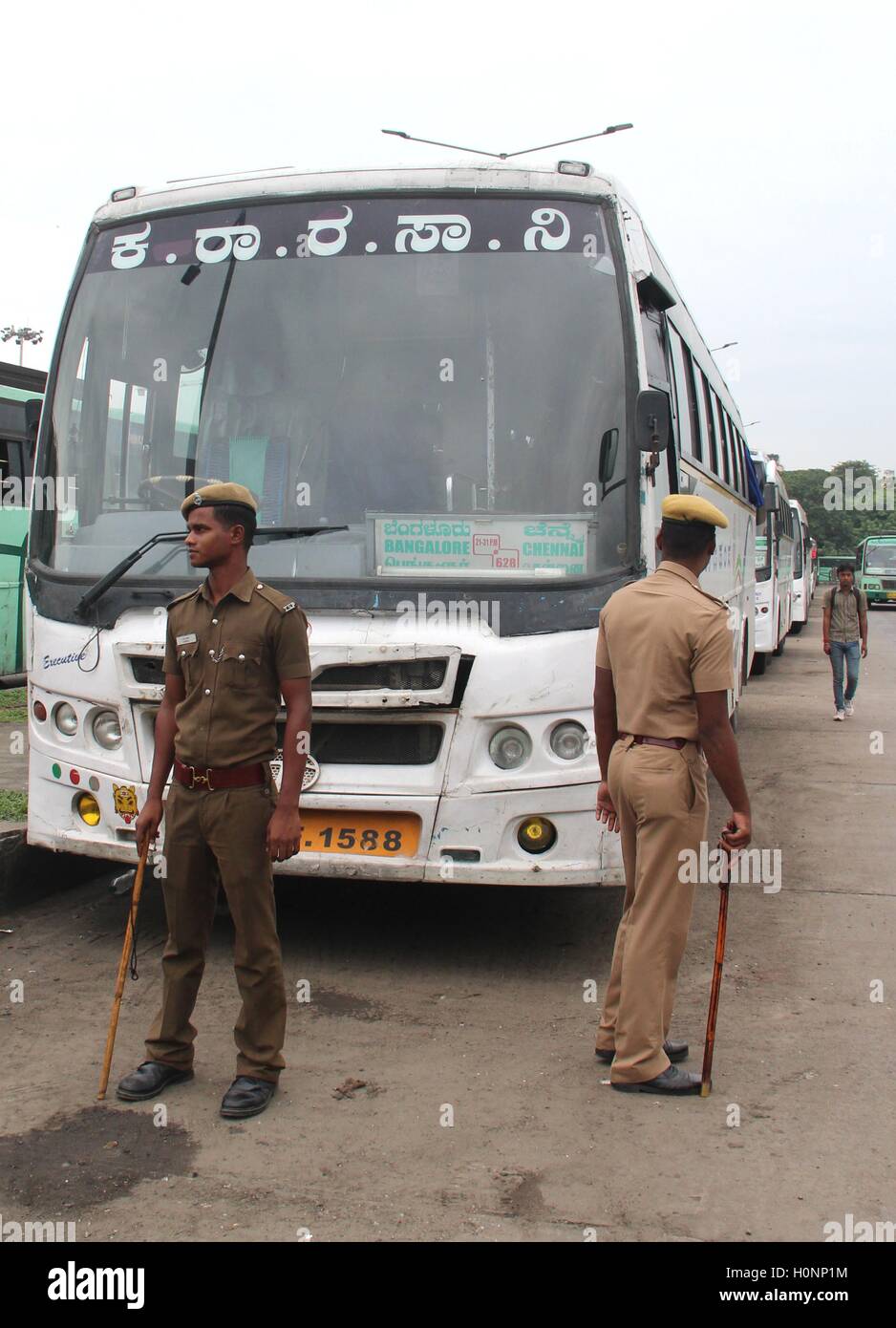 Policemen provide protection to Karnataka buses, in Chennai, Tamil Nadu, India on September 12, 2016 Stock Photo