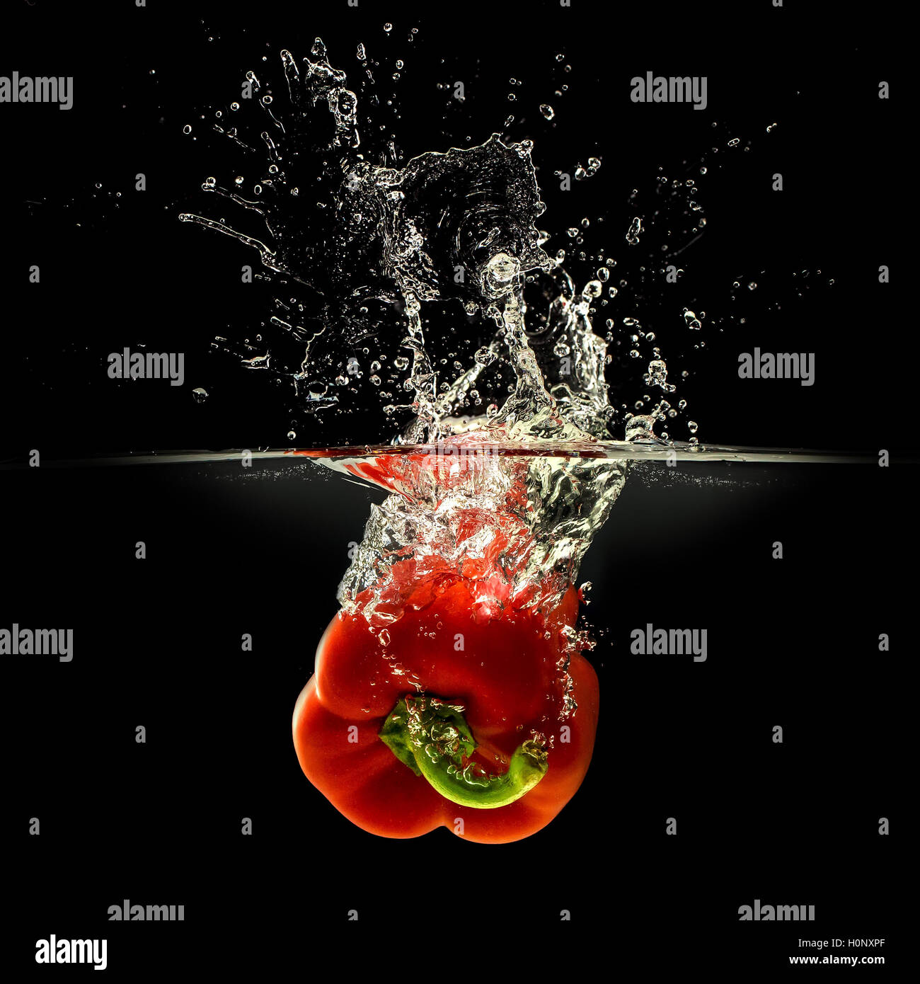 Red bell pepper falling in water on black Stock Photo Alamy
