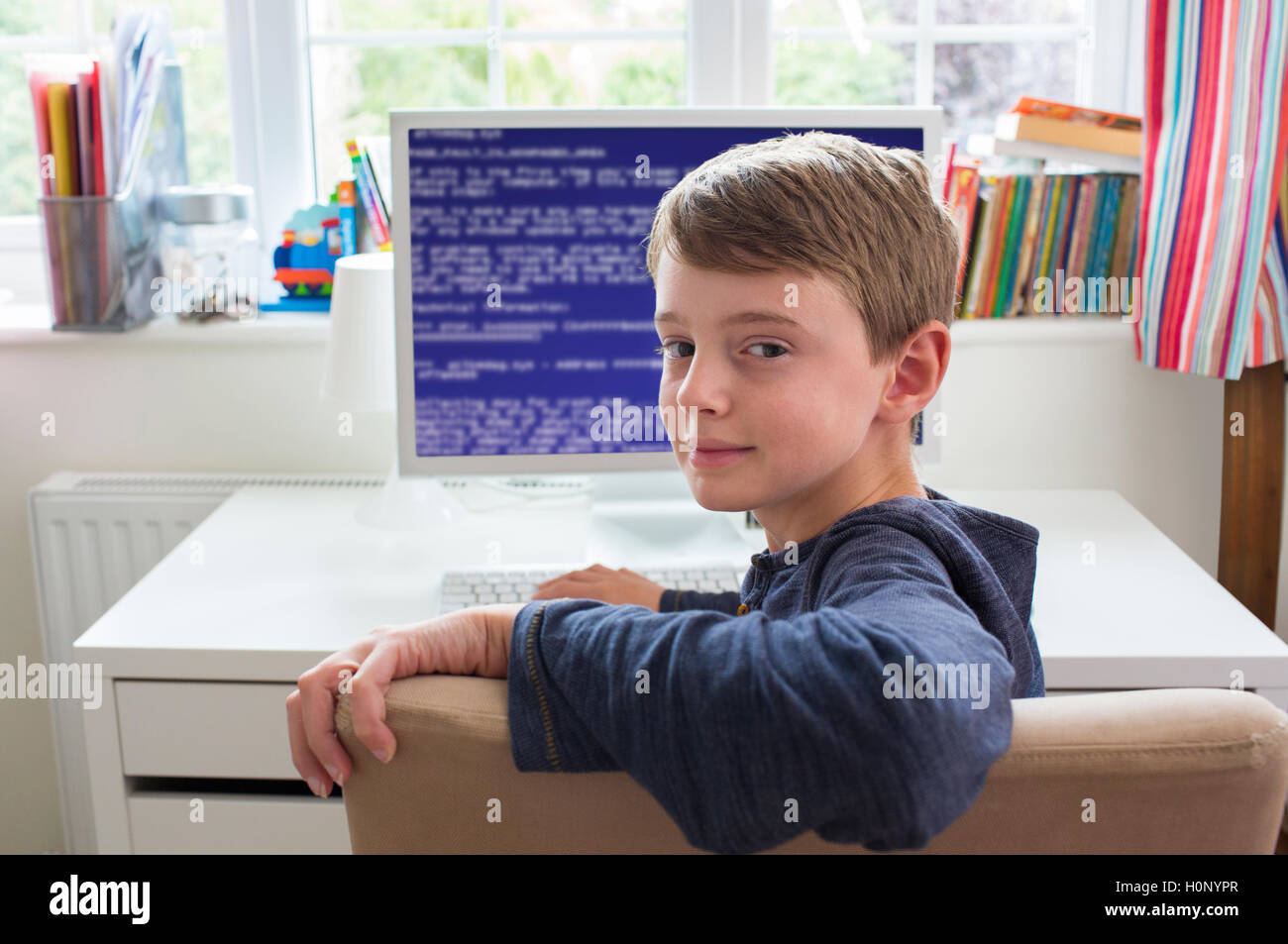 Teenage Boy In Bedroom Writing Computer Code Stock Photo - Alamy