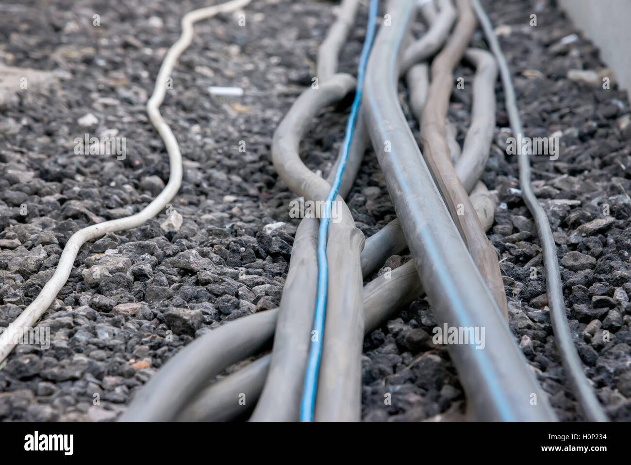 the trail of power electrical cables on the ground Stock Photo