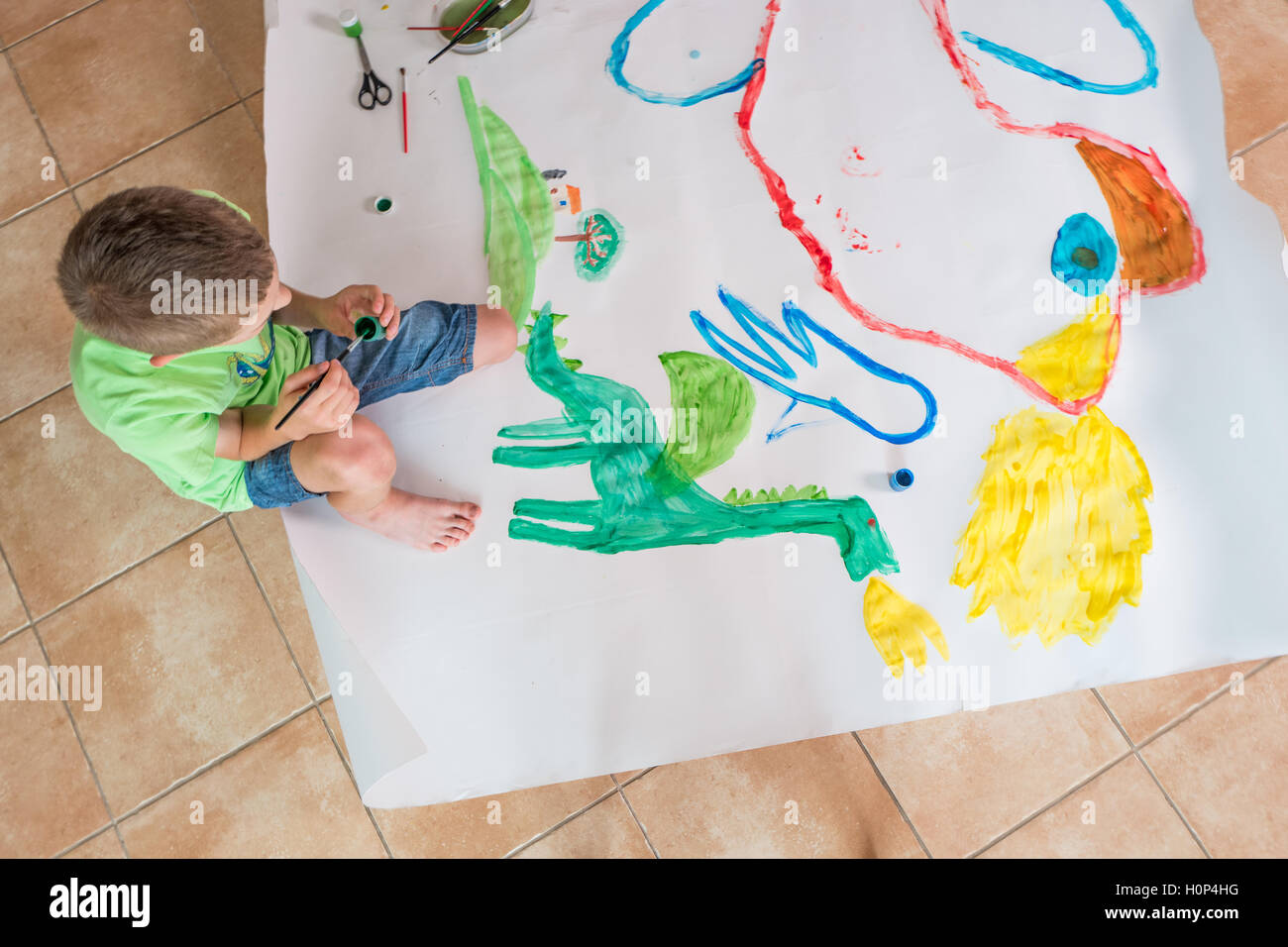 https://c8.alamy.com/comp/H0P4HG/a-boy-painting-a-picture-on-a-big-piece-of-paper-H0P4HG.jpg