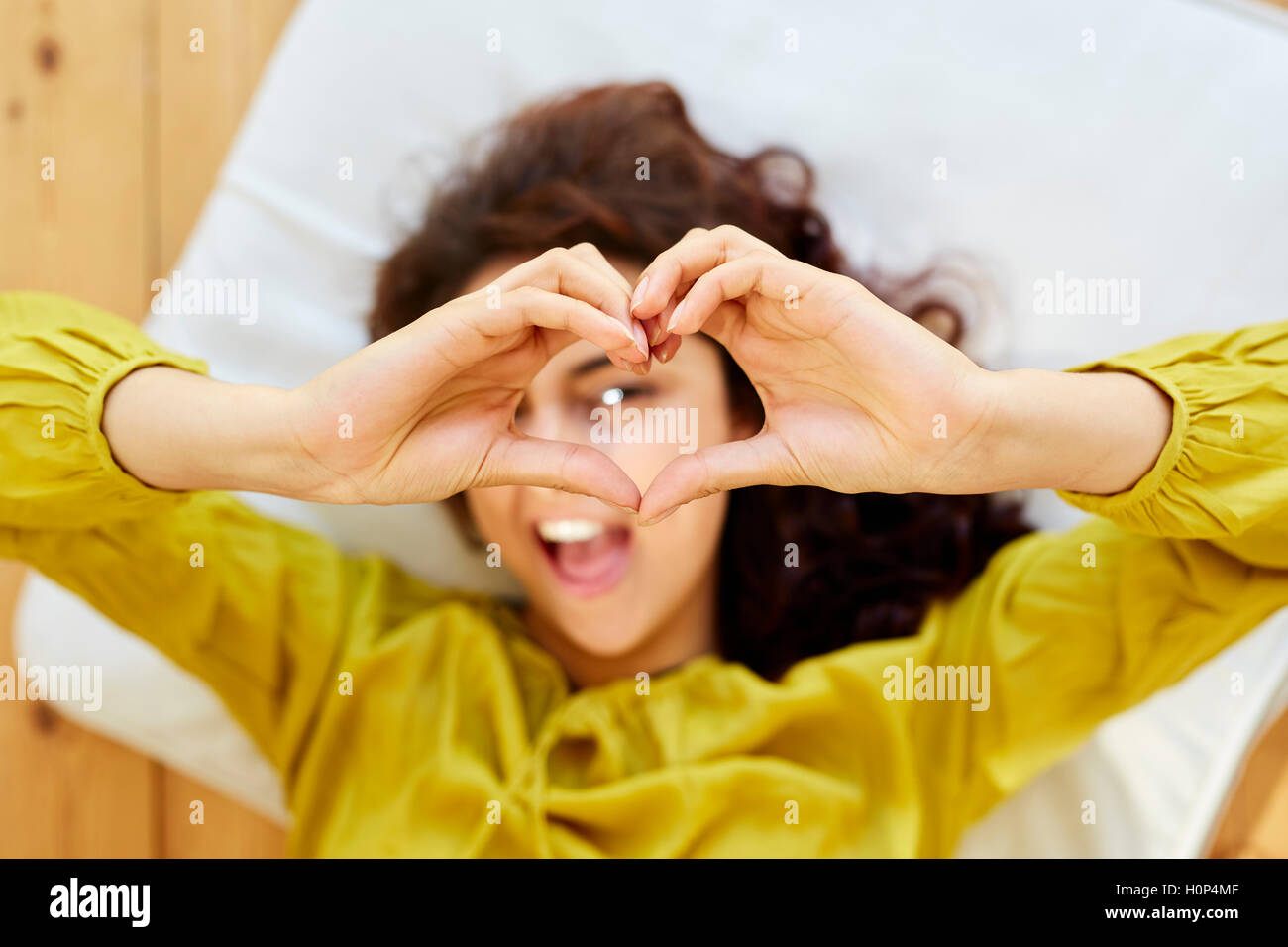 Girl making heart shape with hands Stock Photo