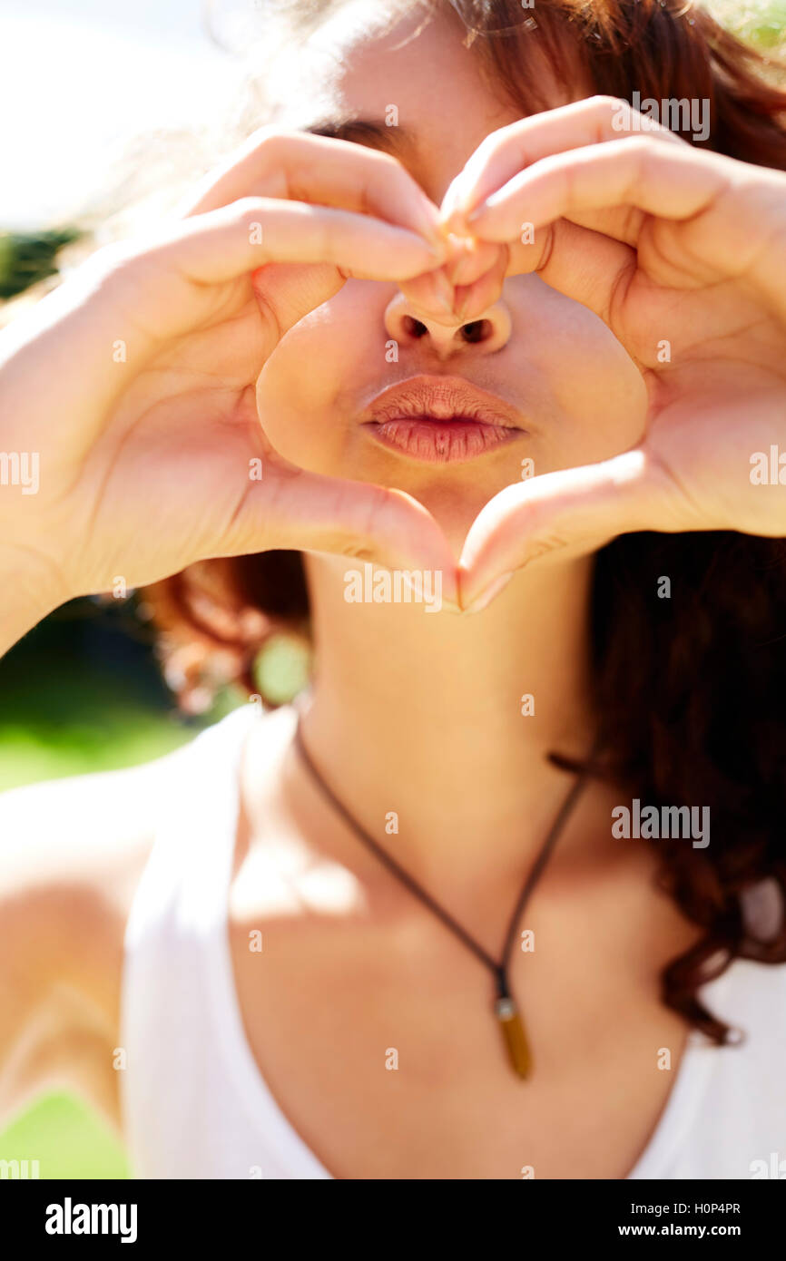 Girl making heart shape with hands Stock Photo