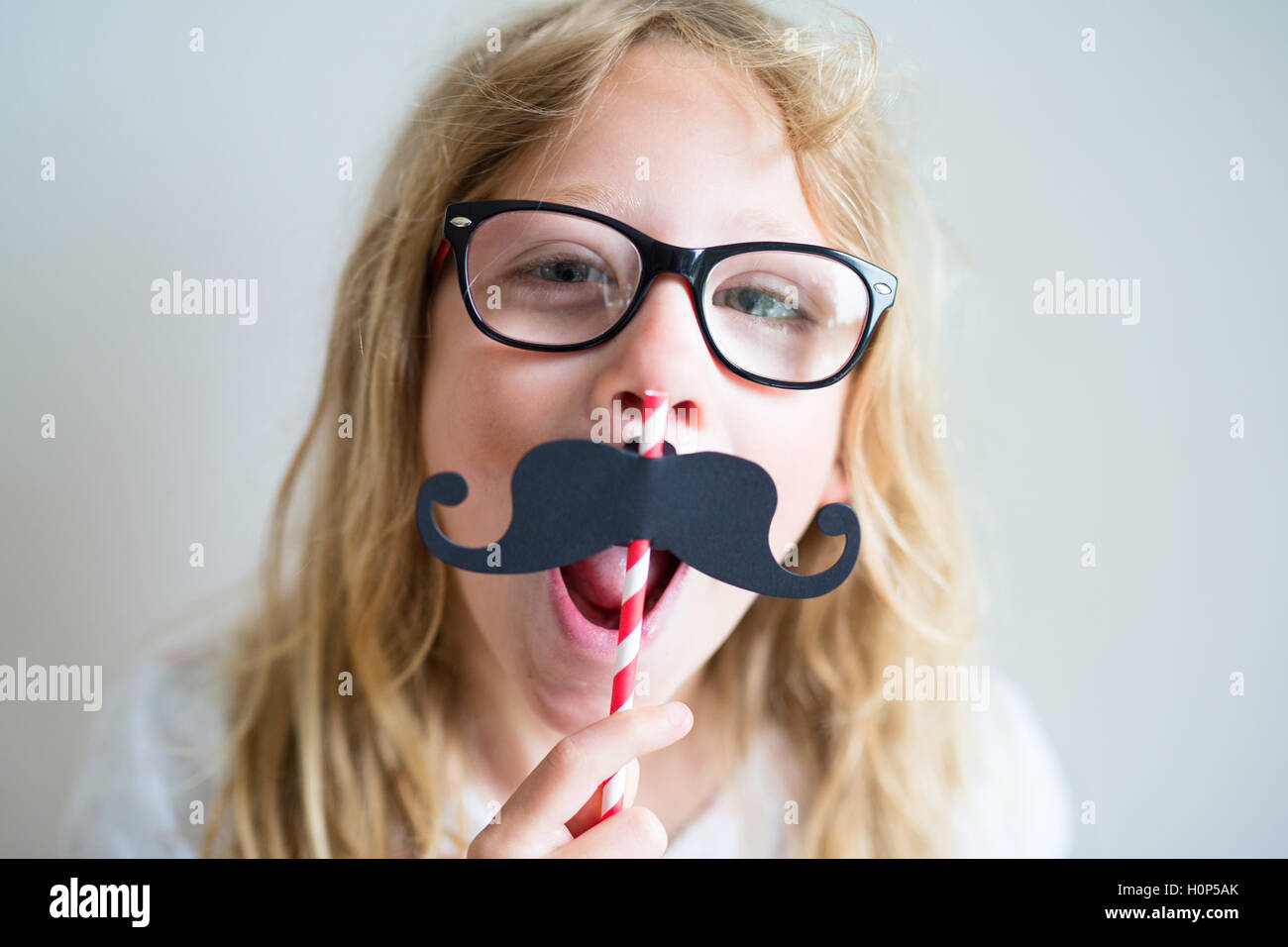 Portrait of a girl with a fake mustache Stock Photo
