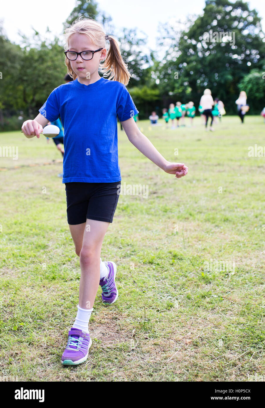 Girl doing egg and spoon race Stock Photo Alamy