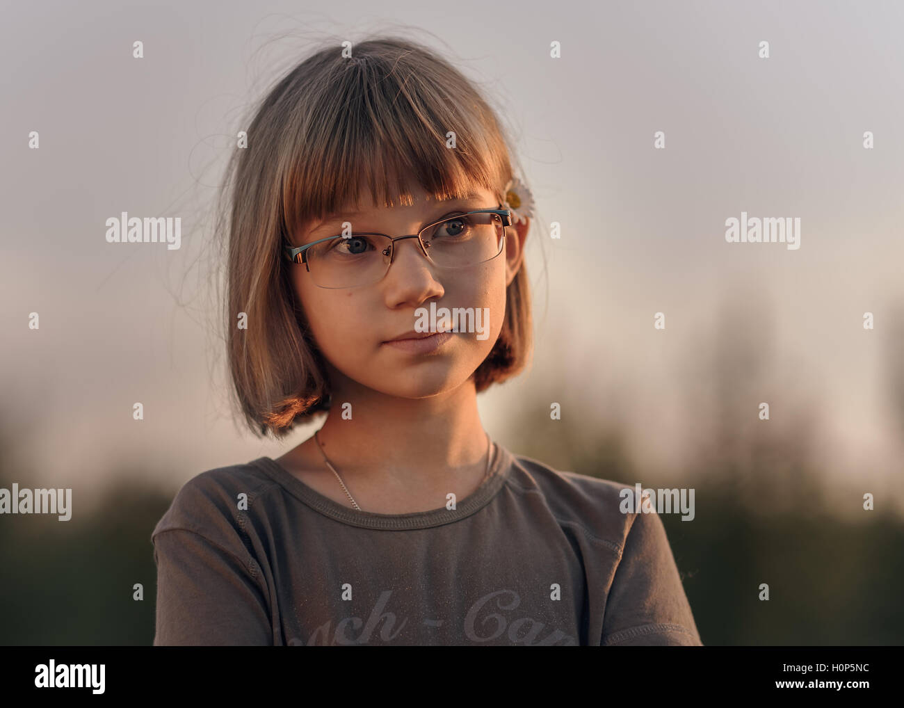 Sad Teenager Girl With Short Blonde Hair And Blue Eyes Against The