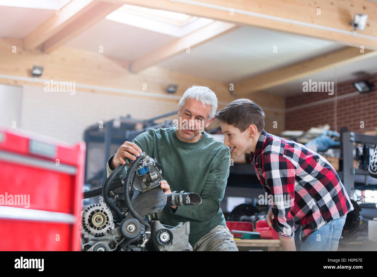 father son rebuilding engine auto repair shop Stock Photo - Alamy