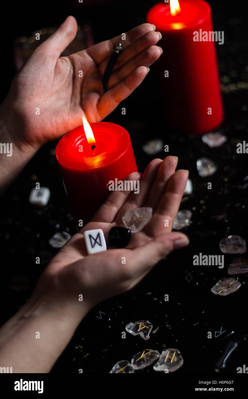 Runi Shaking Hand runes in the hand of the witch Stock Photo - Alamy