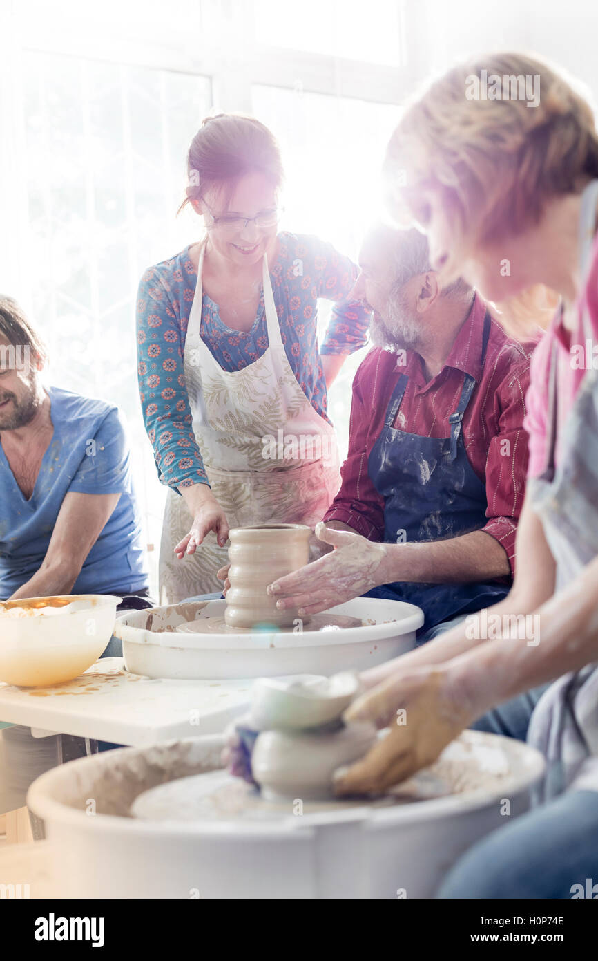 teacher mature student pottery wheel studio Stock Photo - Alamy