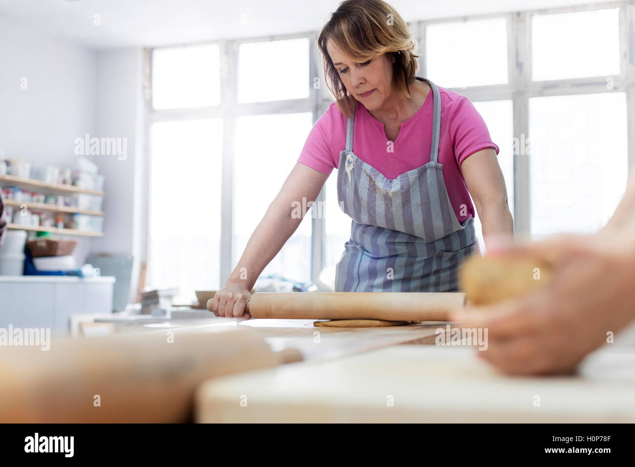 woman rolling clay pin studio Stock Photo Alamy