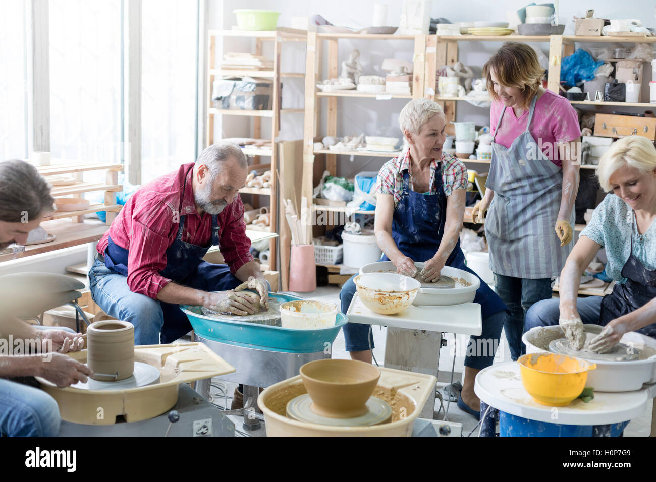mature student using pottery wheel studio Stock Photo Alamy