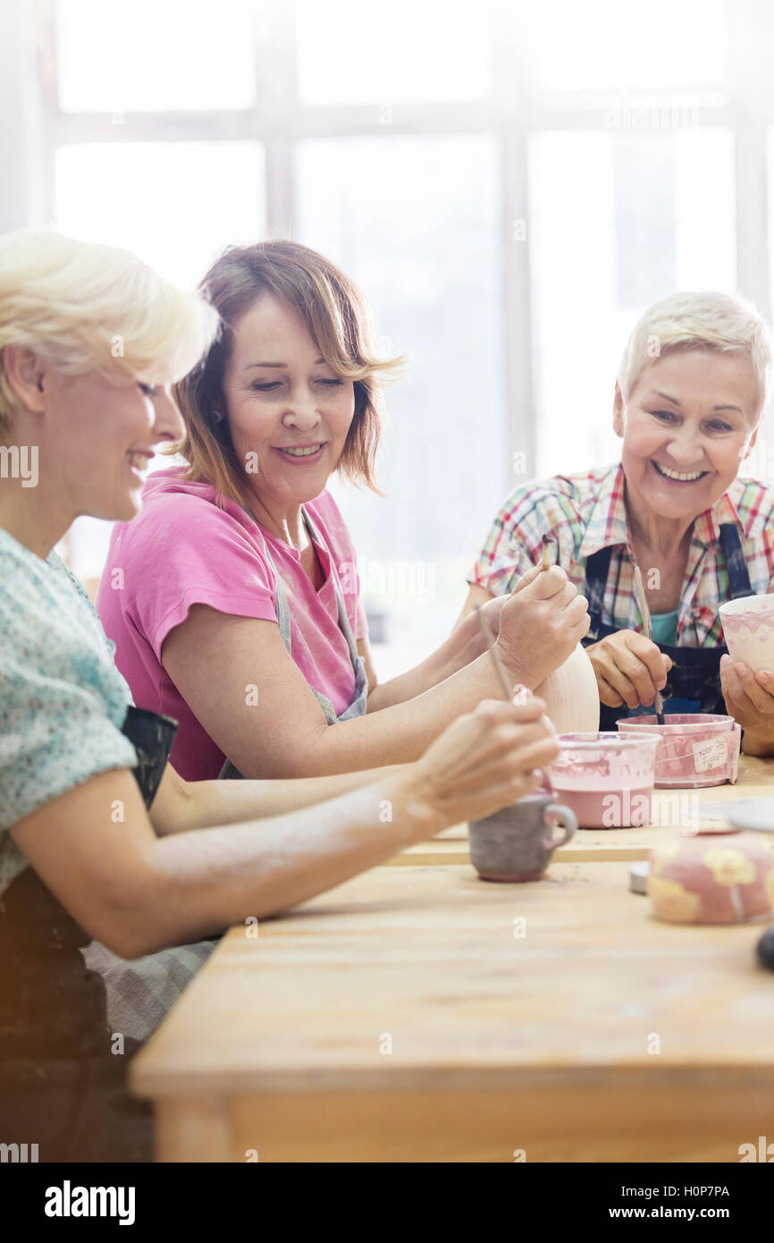 smiling mature woman painting pottery studio Stock Photo - Alamy