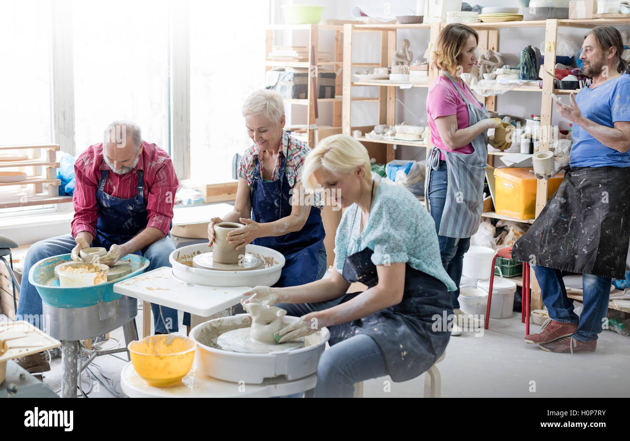 mature student using pottery wheel studio Stock Photo Alamy