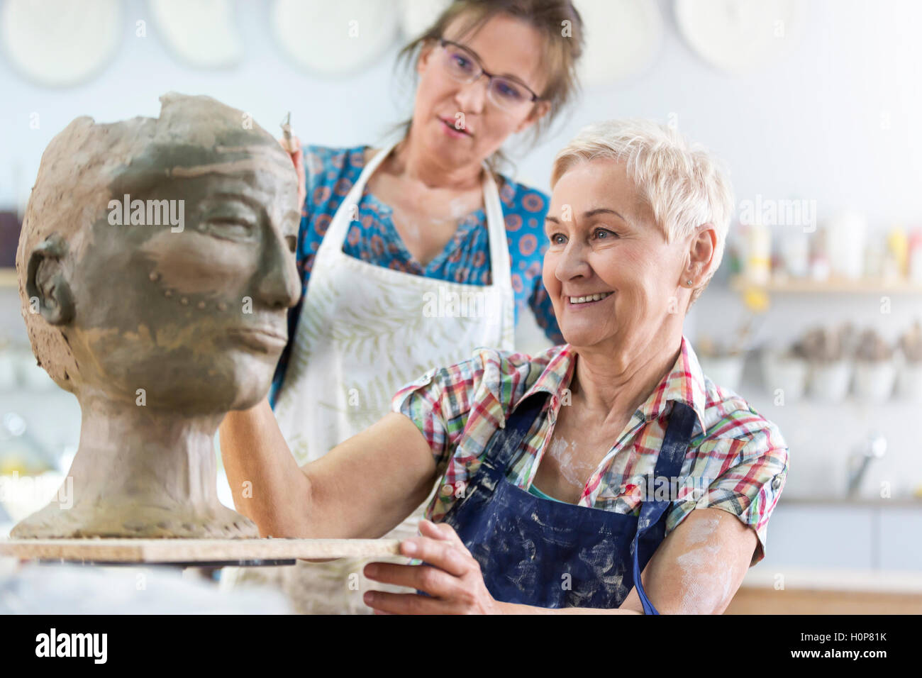teacher woman sculpting clay face pottery studio Stock Photo Alamy