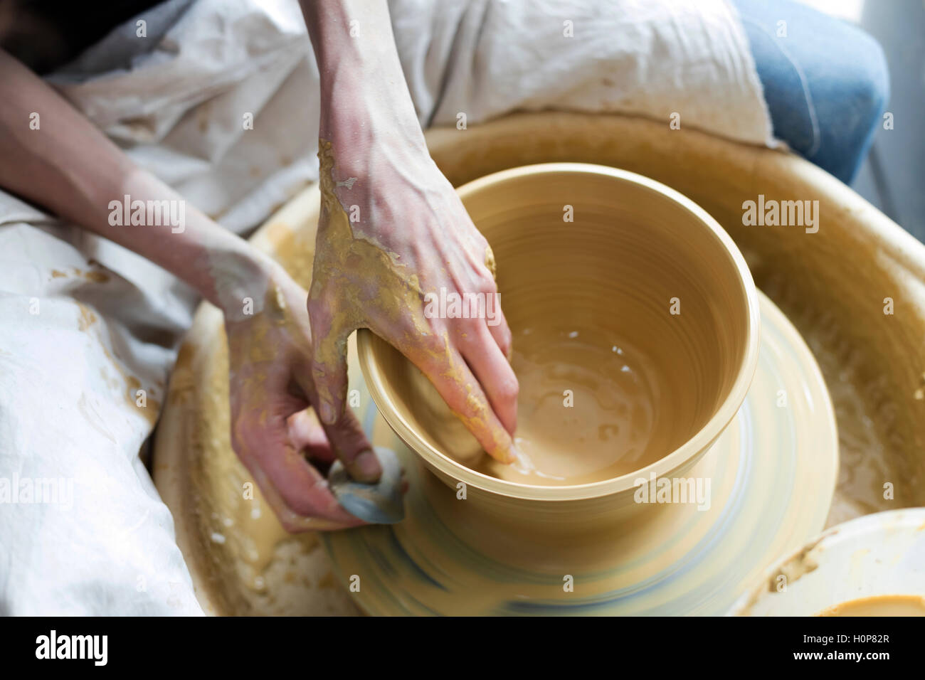 high angle view woman using pottery wheel Stock Photo