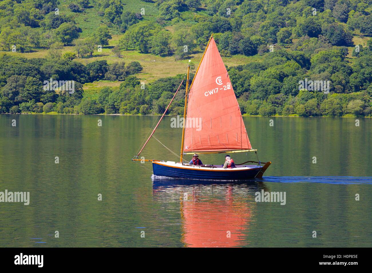 Orange sailed boat sailing near Glencoyne. Ullswater, Penrith, The Lake District National Park, Cumbria, England, United Kingdom Stock Photo