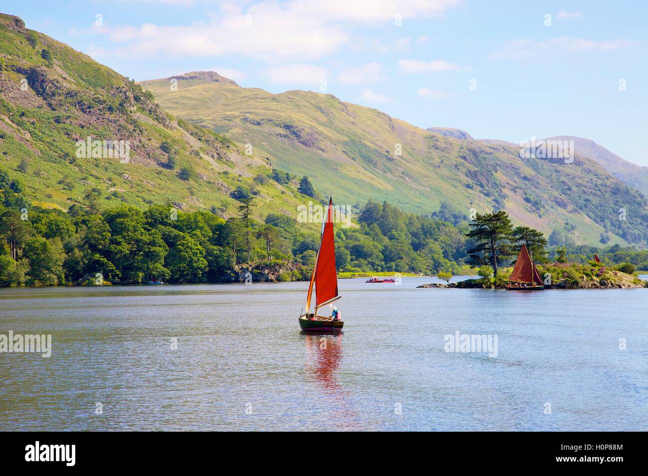 Red sailed boat sailing near Wall Holm island. Ullswater, Penrith, The Lake District National Park, Cumbria, England, UK. Stock Photo