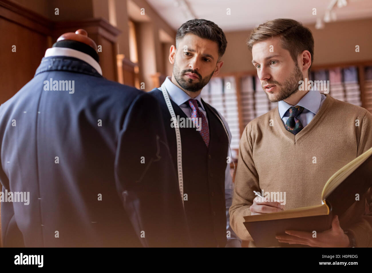 tailor suit taking notes menswear shop Stock Photo