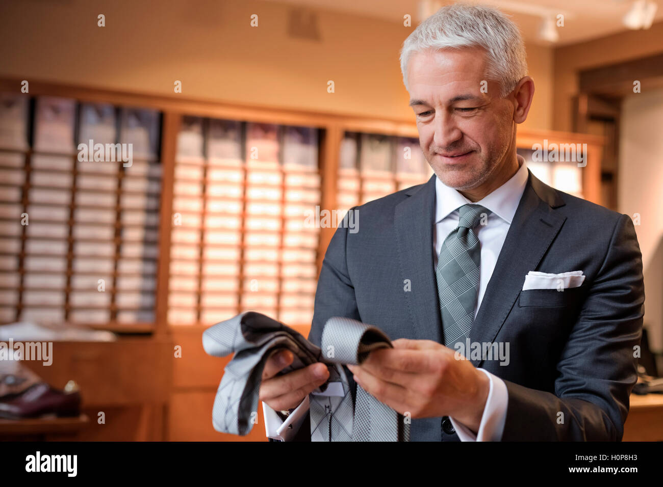 businessman browsing tie menswear shop Stock Photo