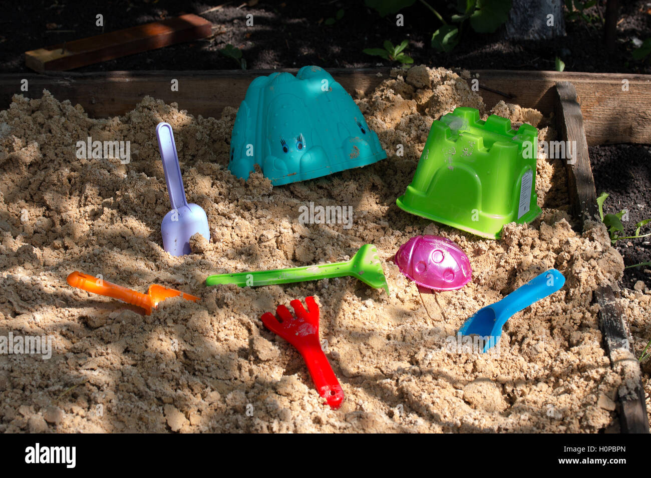 children's toys are in the sandbox Stock Photo