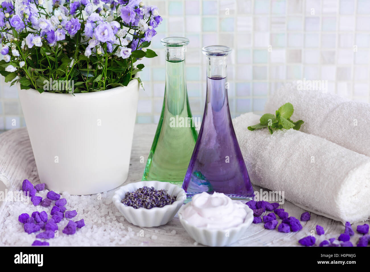 Still Life Massage Oil In Bottles With Flowers On A Tray Towels Stock Photo Alamy