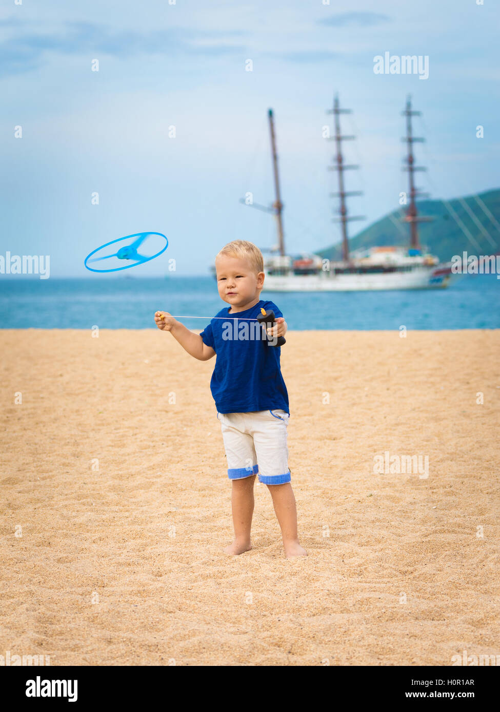 Boy with flying saucer outdoor. Leisure activity Stock Photo Alamy