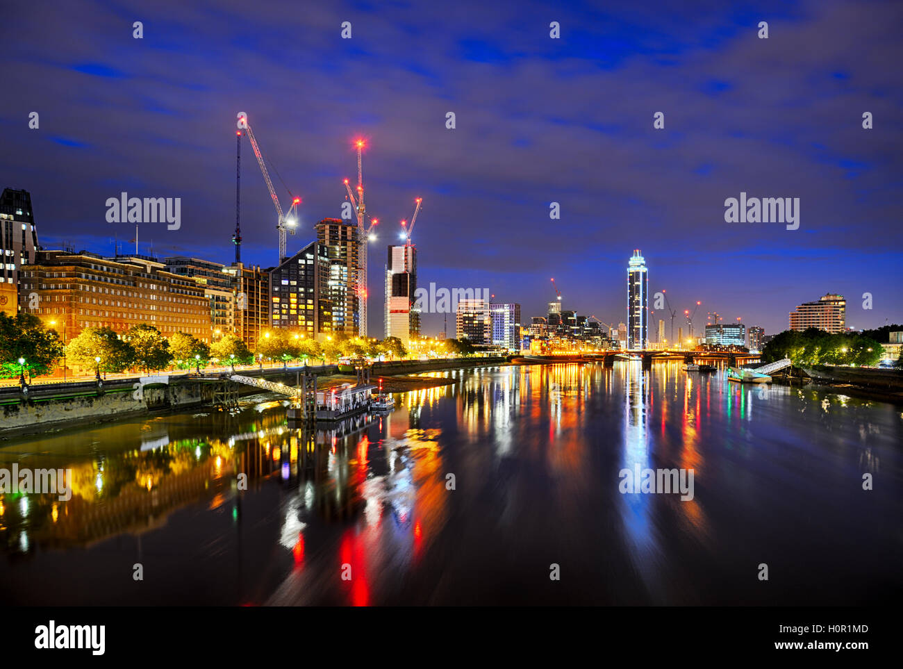 View of London at night from Lambeth Bridge showing St Georges Wharf and St Georges Tower cranes and River Thames Stock Photo