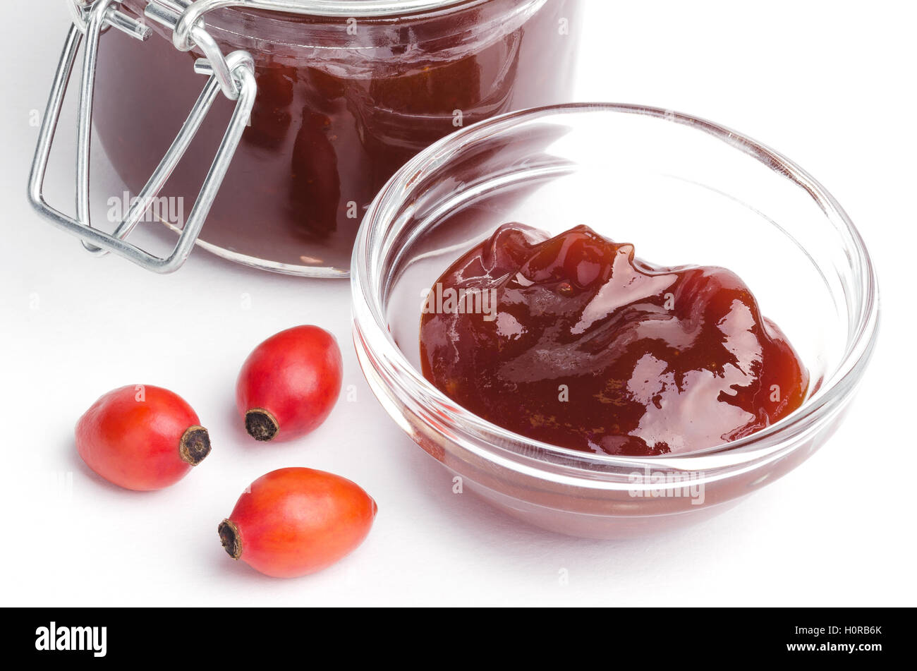 Rose hip jam and fruits from above over white, also rose haw or rose