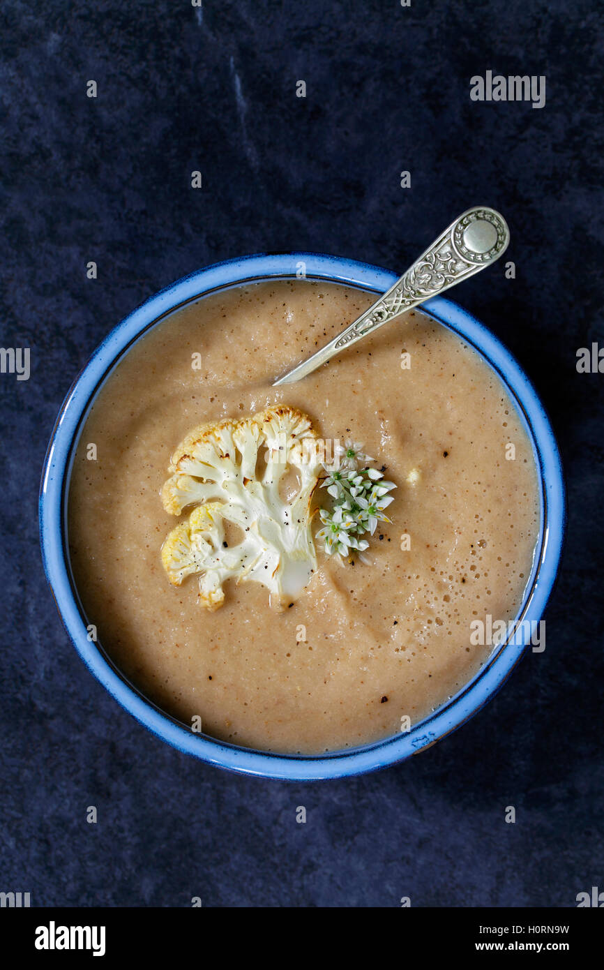 Roast cauliflower soup with wild garlic flowers Stock Photo