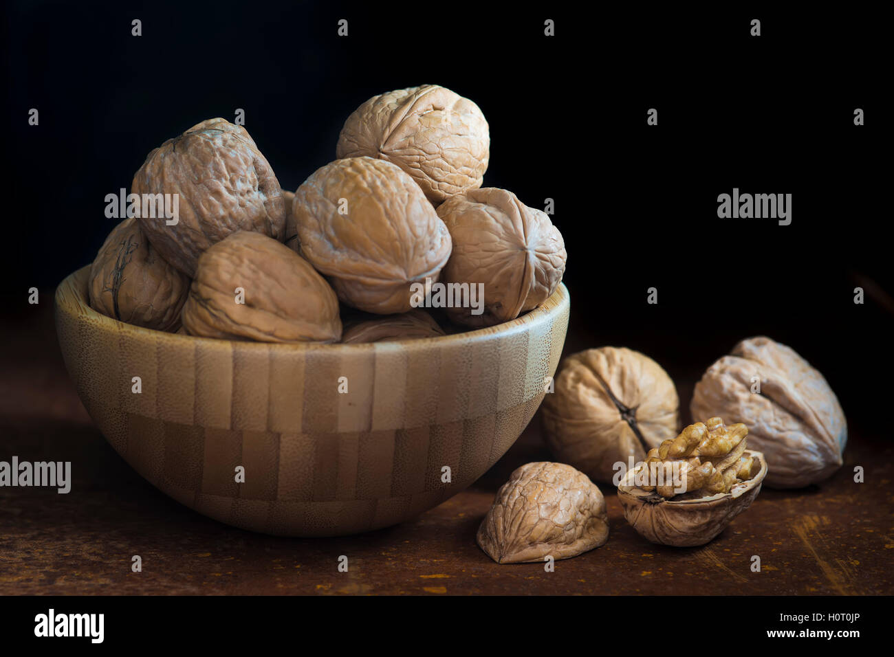 Wooden bowl with walnuts on a dark background Stock Photo