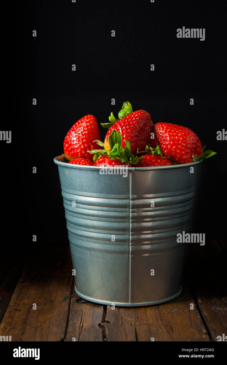 Bucket with fresh strawberries on a black background Stock Photo - Alamy