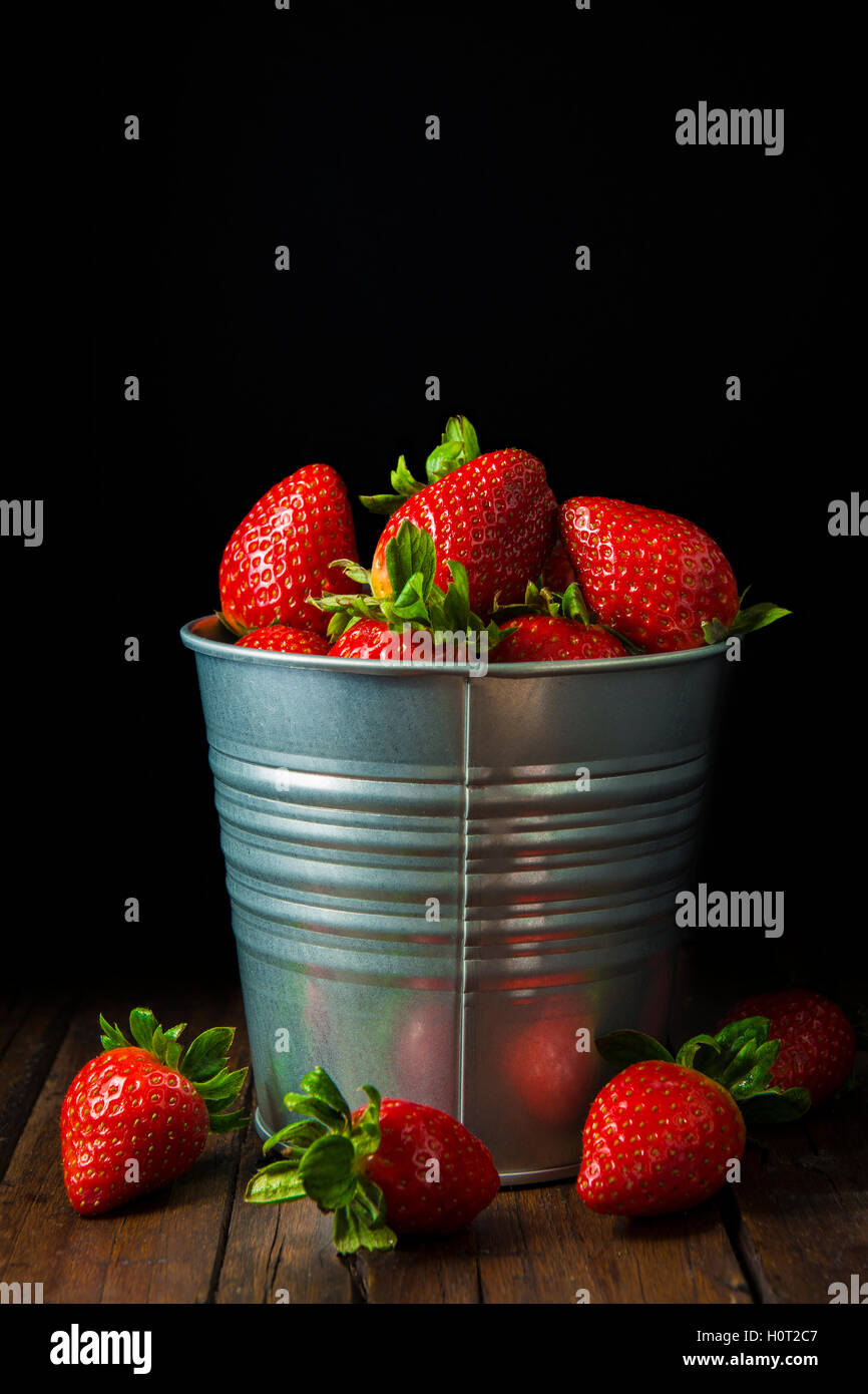 Bucket with fresh strawberries on a black background Stock Photo - Alamy