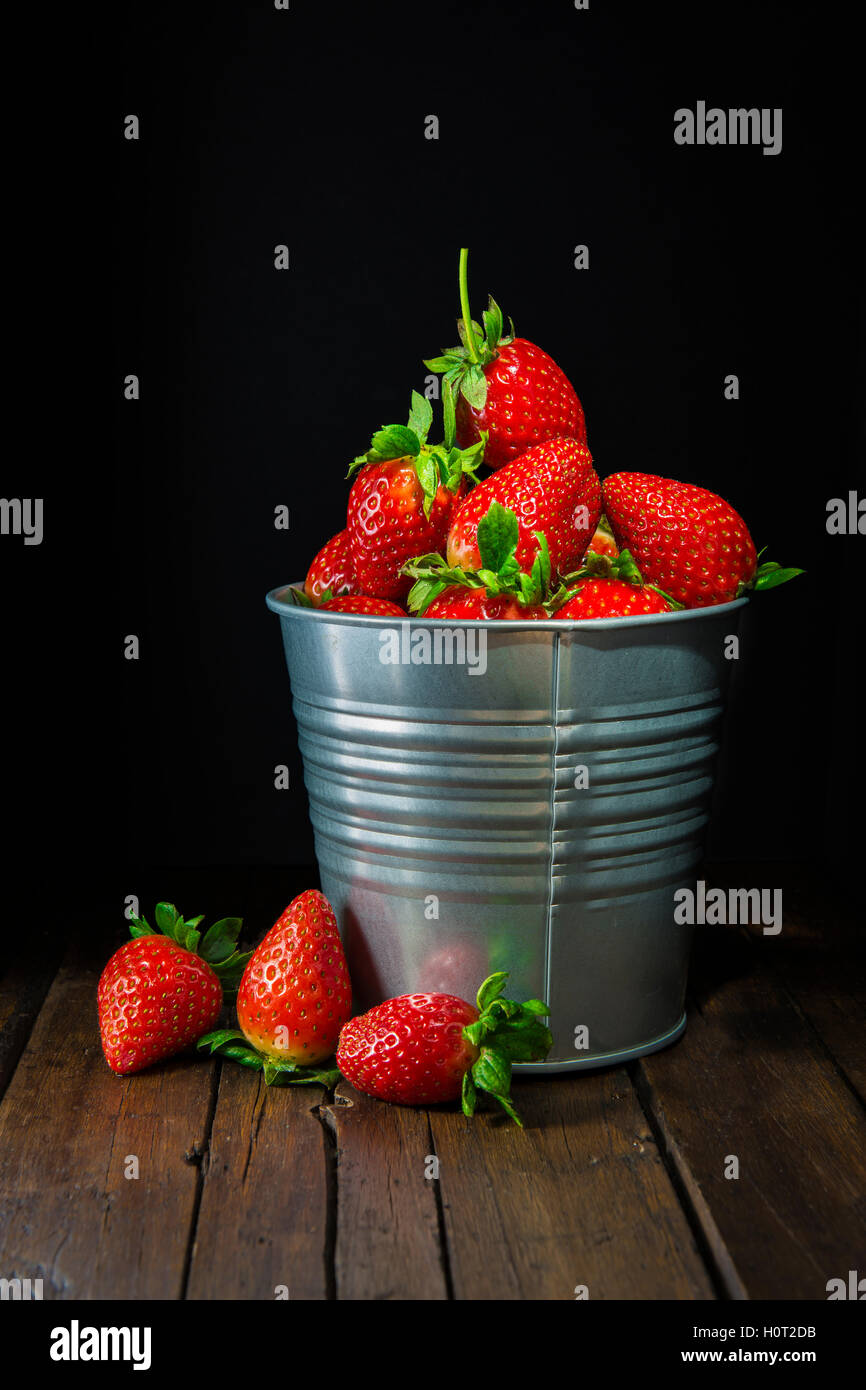 Bucket with fresh strawberries on a black background Stock Photo - Alamy