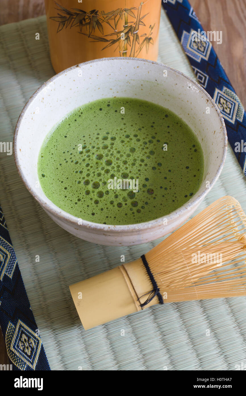 Japanese Matcha green tea in a chawan or traditional ceramic bowl with a tatami mat background Stock Photo