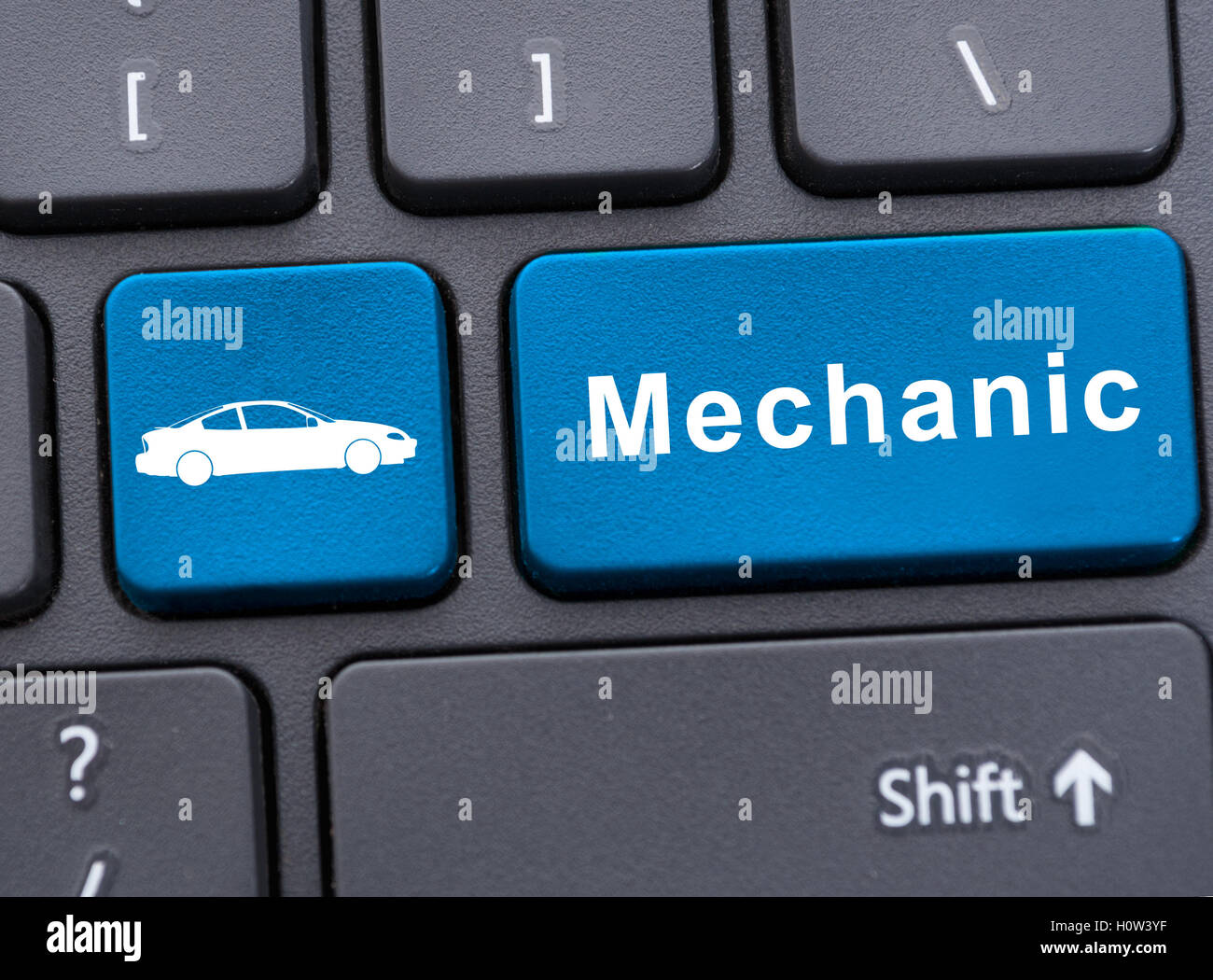 Online auto service concept with car symbol and mechanic word on blue key Stock Photo