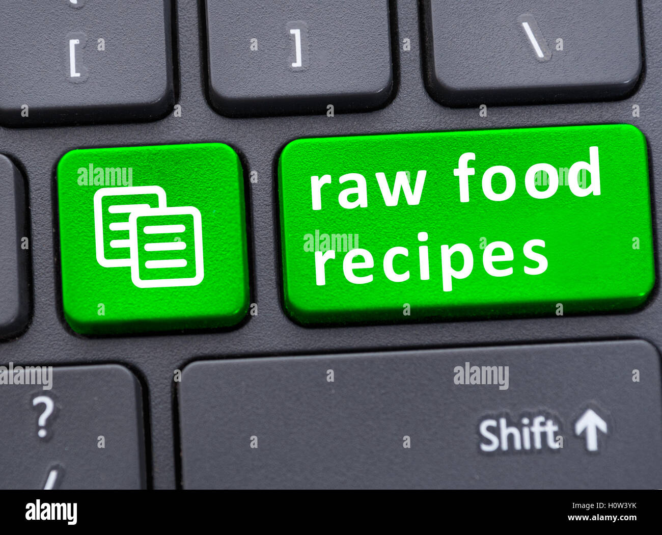 Online guide of healthy food concept with raw food recipes on laptop keyboard Stock Photo