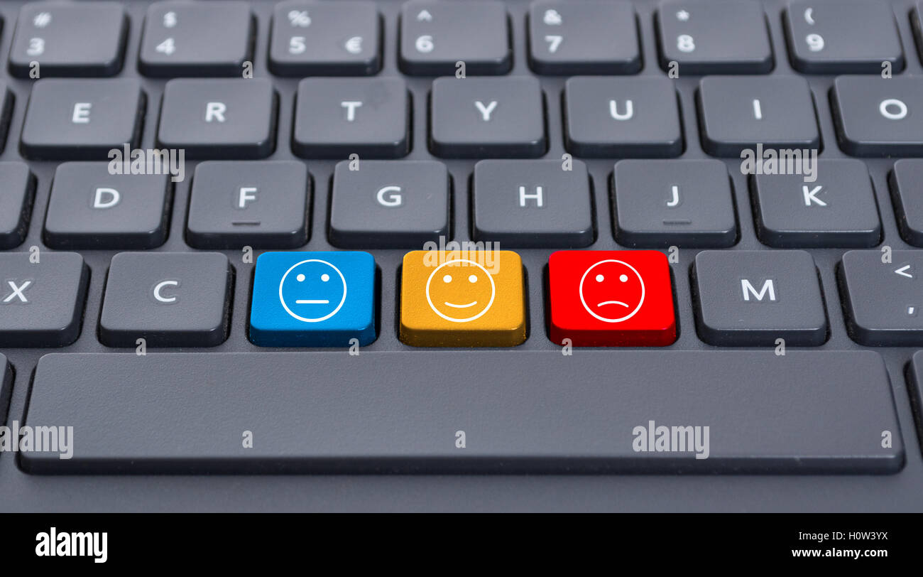 Close-up computer keyboard with three smiley keys or emoticons as feeling  or emotions concept Stock Photo - Alamy